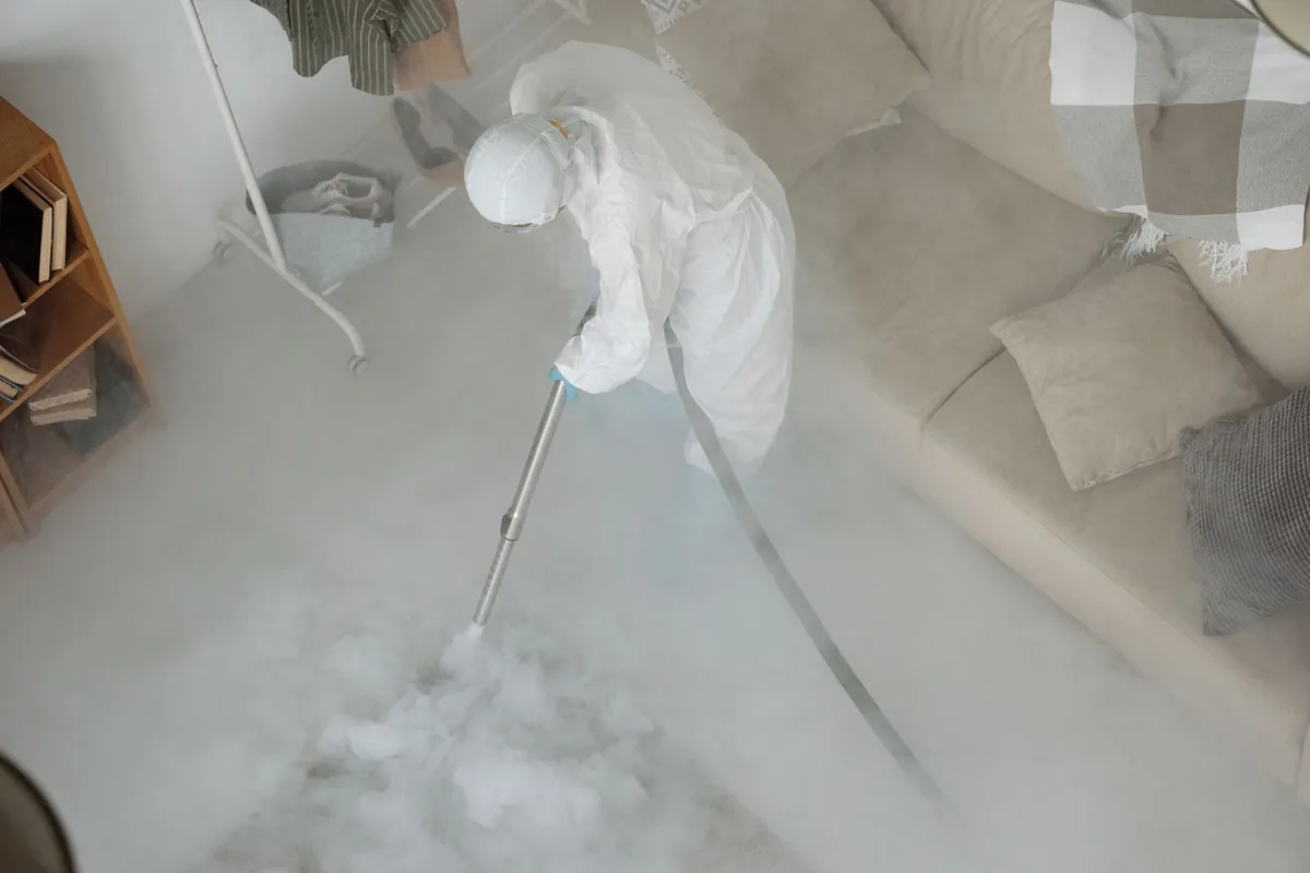 Biohazard cleanup technician in protective equipment, Brinkley, AR